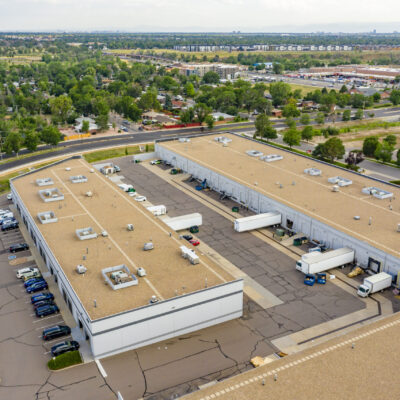 Aerial photo of light-industrial property Commerce Square, showing truck bays, parking, and surrounding trees